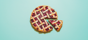 Cherry pie on teal background with single slice cut out