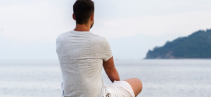 Man being mindful while watching the ocean